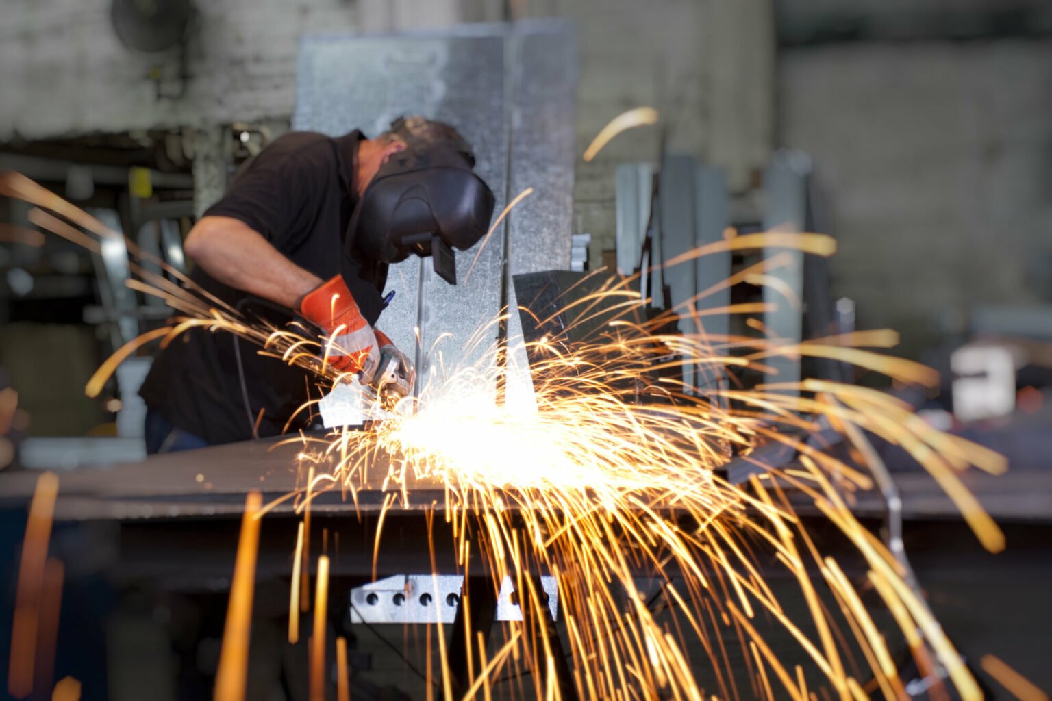 Sparks,Frying,Over,The,Working,Table,During,Metal,Grinding