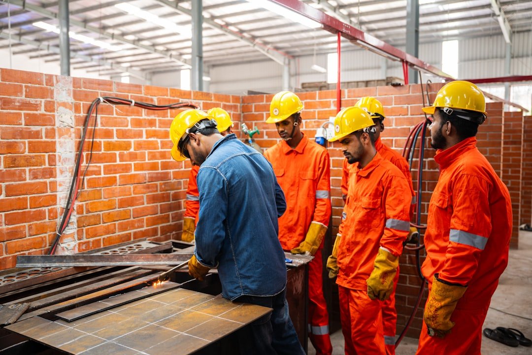 Structural steel fabrication workshop — cutting and assembly of steel members on the shop floor