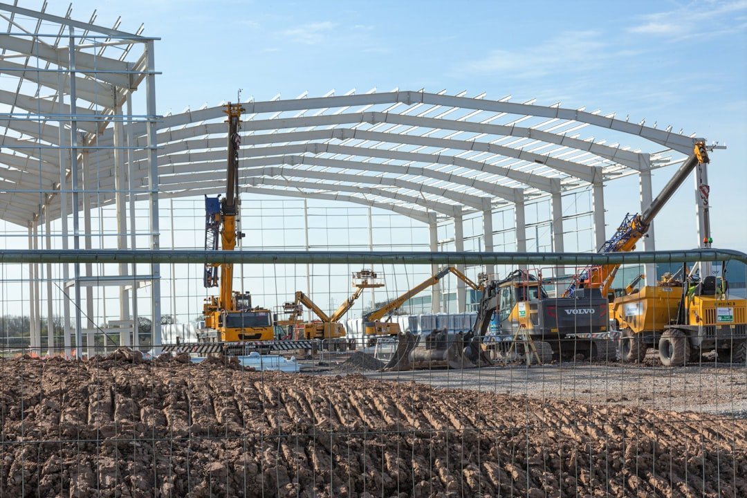 Steel frame and roof truss erection in progress at a construction site
